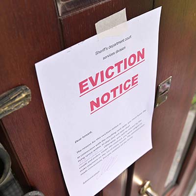Eviction notice taped to the front door of a rental property
